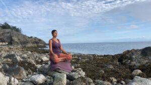 Farah Nazarali Meditating on the beach near Nanaimo BC