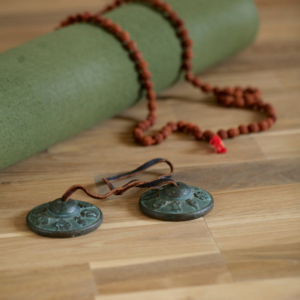 Teaching Yoga Without Cultural Appropriation: Yoga mat with Tingsha Chimes, and Rudraksha Beads