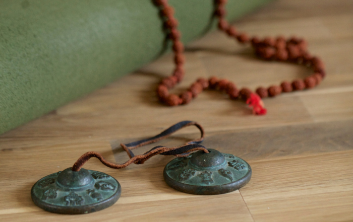 Teaching Yoga Without Cultural Appropriation: Yoga mat with Tingsha Chimes, and Rudraksha Beads
